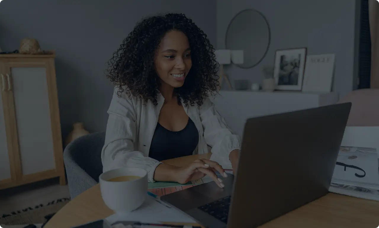 Smiling businesswoman working on a laptop in a stylish home office